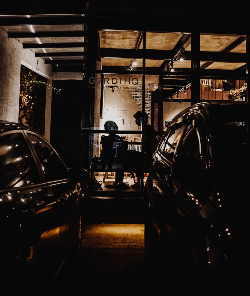 light, building, night, city, business, seat, car, built structure, machinery, romantic, couple, urban, cars, industry, person, illuminated, garage, machine part