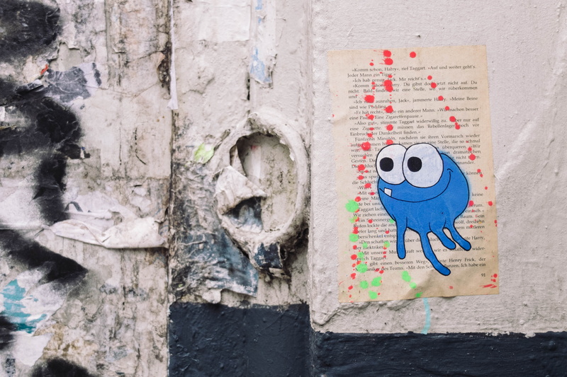 book, close-up, white, weathered, anthropomorphic smiley face, built structure, wall - building feature, outdoors, art and craft, bookpage, mural, stone wall