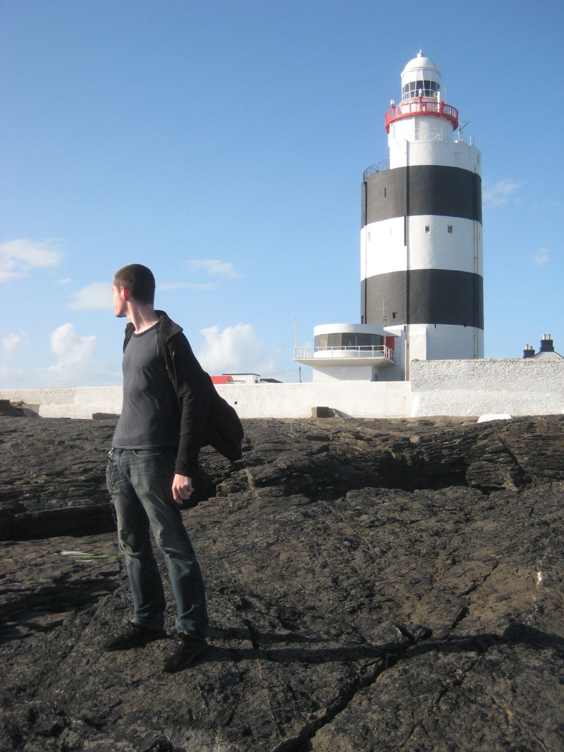 sky, real people, coast, landmark, built structure, standing, building exterior, males, casual clothing, 2K, ireland, nature, young men, sunlight, architecture