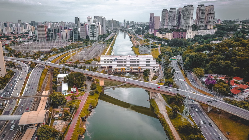 2K, outdoors, office building exterior, no people, building exterior, aerial view, transportation, water, tree, built structure, brazil, multiple lane highway