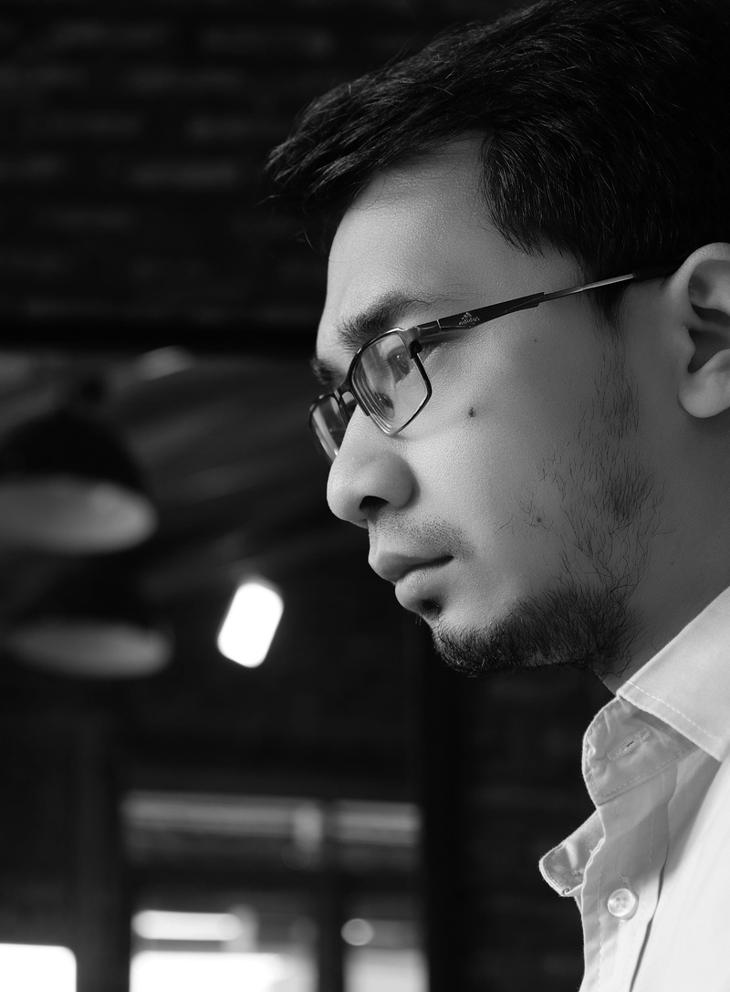real people, headshot, close-up, contemplation, working, focus on foreground, portrait, sunglasses, thinking, beard, one person, side view, black and white