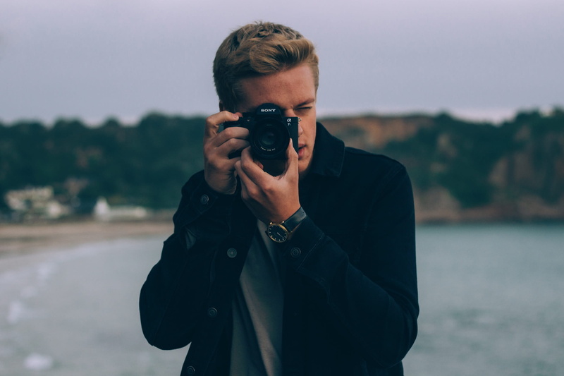 real people, boy, activity, lifestyles, young men, photography themes, guy, occupation, waist up, holding, obscured face, digital camera, one person, people