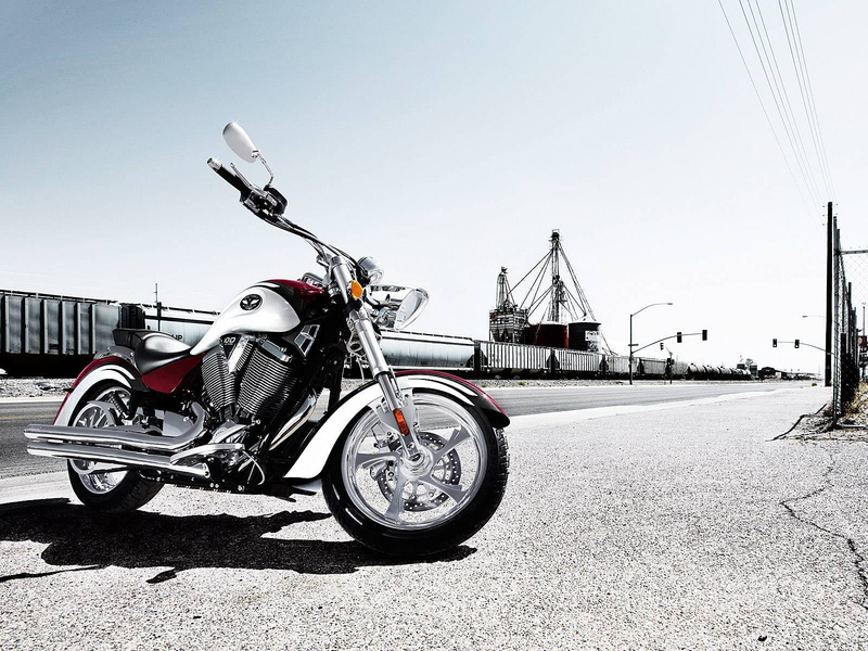 city, building exterior, Motorcycles, outdoors, Victory, bicycle, gray, cruiser, white, transportation, street, stationary, sky, road, day, sunlight, mode of transportation
