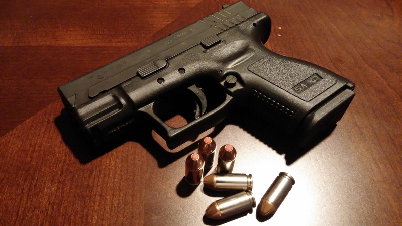 crime, semi, xd subcompact 40, indoors, hollowpoint, aggression, table, xd subcompact, wood - material, studio shot, security, social issues, weapons, communication