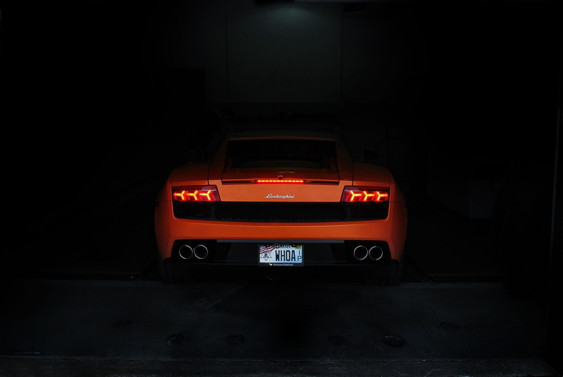 black background, no people, parking garage, car, studio shot, illuminated, tool, transportation, black, sports car, box, dark, indoors, city, night, craftsman