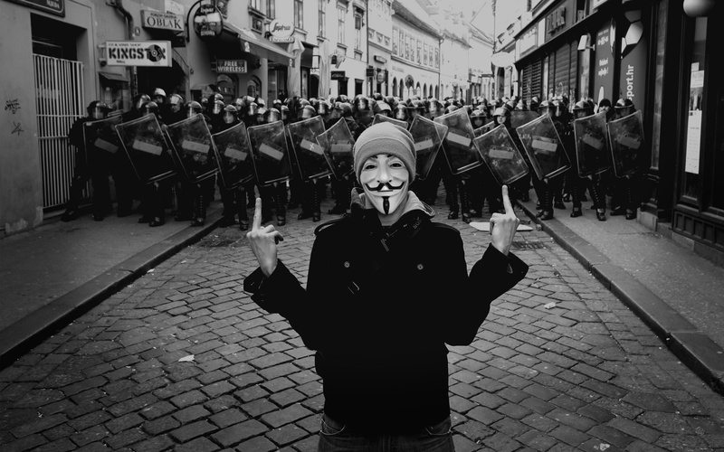 mask, guyfawkes, looking at camera, beautiful woman, street, built structure, clothing, warm clothing, waist up, young women, 2K, standing, women, leisure activity