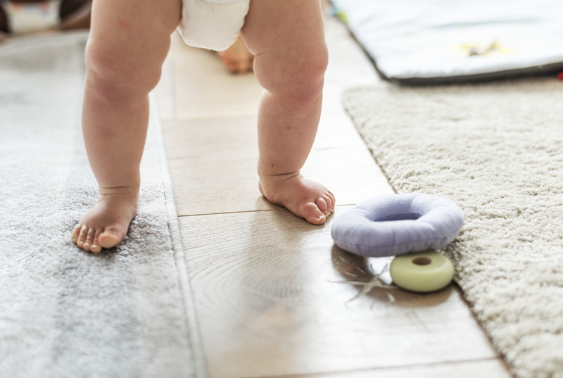 real people, diaper, flooring, body part, growing, healthy lifestyle, home, growth, babyhood, innocent, low section, sport, human body part, carpet, wellbeing
