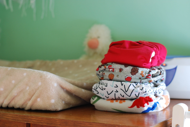 representation, newborn, cloth, boy, food, close-up, table, pile, wood - material, creativity, red, new, still life, indoors, diapers, changing, girl, dots