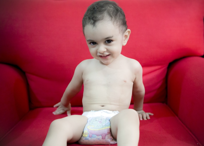 looking at camera, one person, three quarter length, childhood, smiling, red, portrait, summer, hot, innocence, boy, shirtless, indoors, front view, beloved