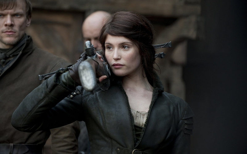 Movie, young women, adult, confidence, waist up, emotion, looking at camera, front view, portrait, leather, hairstyle, indoors, weapon, focus on foreground
