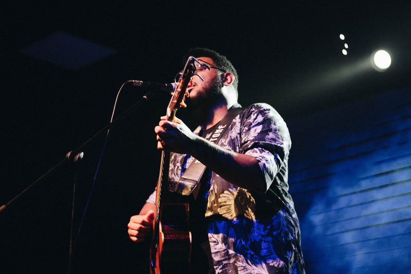 performing arts event, microphone, illuminated, black, church, 5K, front view, guitar, young adult, stage light, stage - performance space, three quarter length