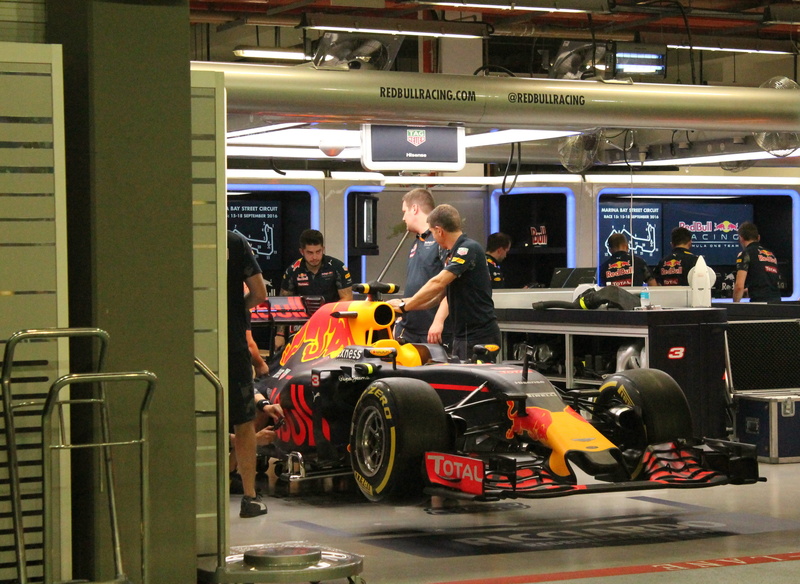 race car, public transportation, real people, motion, indoors, Car, travel, Engine, standing, rail transportation, box, Vehicle, car, group of people, males