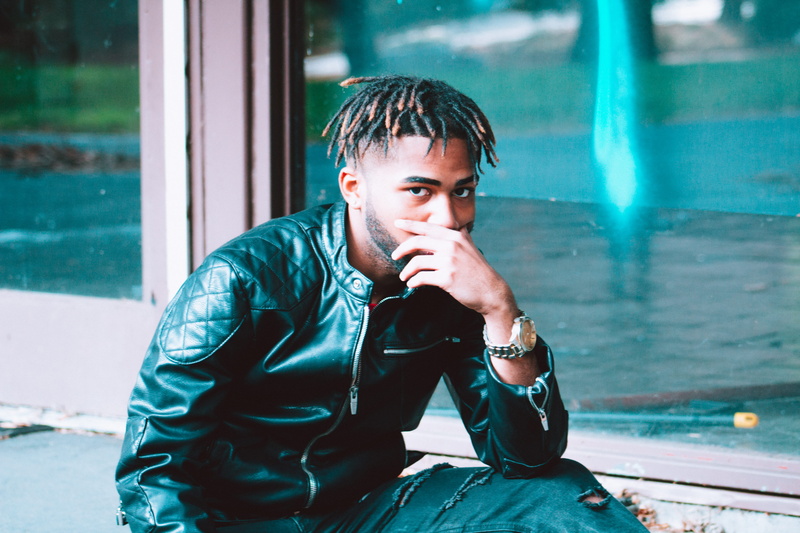 real people, portrait, color, looking at camera, cold, outdoors, african, young adult, focus on foreground, urban, united states, uzi, window, shadows