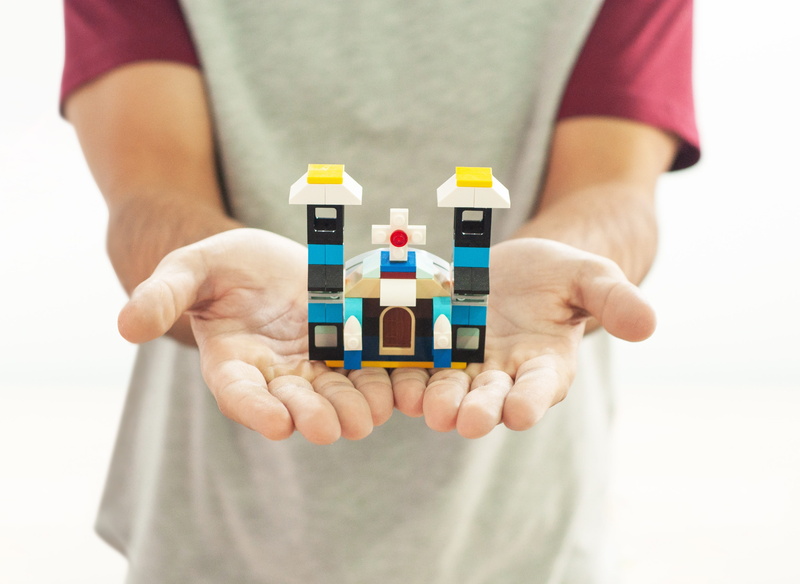 indoors, multi colored, holding, midsection, lego, mount, casual clothing, standing, church, community, human hand, front view, human body part, one person