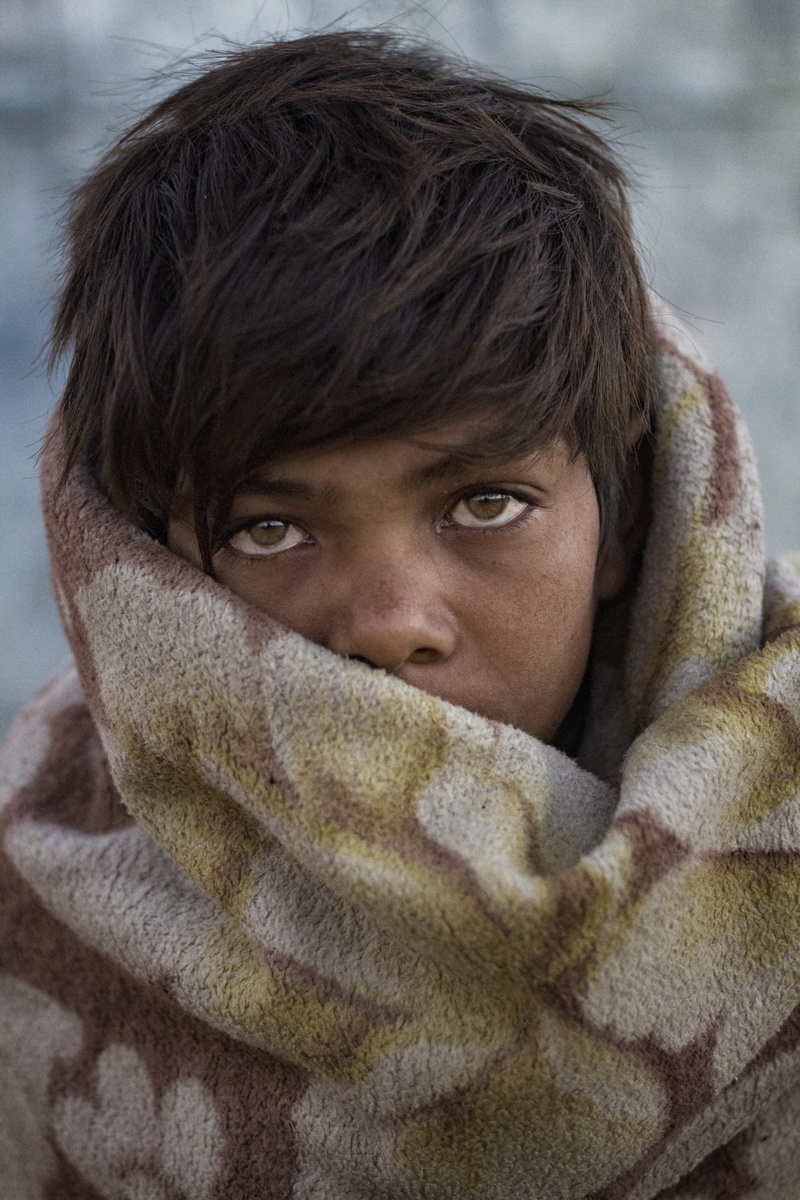 looking at camera, clothing, hood - clothing, human face, lifestyles, hair, warm clothing, blurred background, headshot, wrapped in a blanket, boy, obscured face