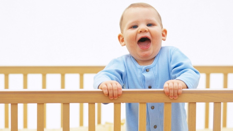baby, nursery - Bedroom, childhood, facial Expression, bed, playful, mouth, human body part, cute, indoors, new Life, joy, looking, blue, button, happy