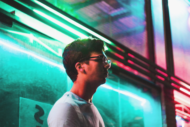 man, side view, 5K, person, young men, contemplation, one person, glass, wall, night, standing, adult, facial hair, profile, waist up, portrait, neon light