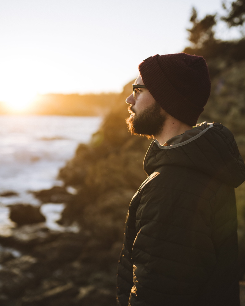 looking away, sea, profile view, lifestyles, facial hair, focus on foreground, 2K, side view, outdoors, waist up, beard, young adult, contemplation, standing