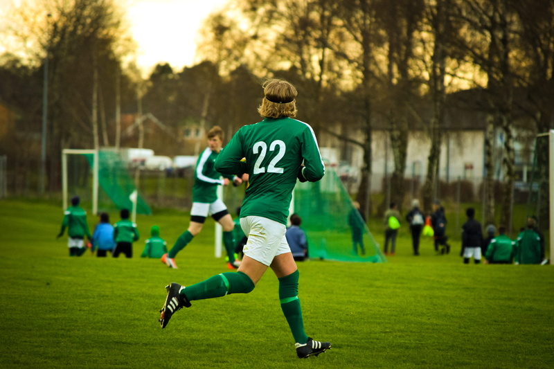 game, people, soccer, shorts, ball, man, sports, athletes, two, youth, playing, soccer team, sports clothing, teamwork, teens, wear, focus on foreground