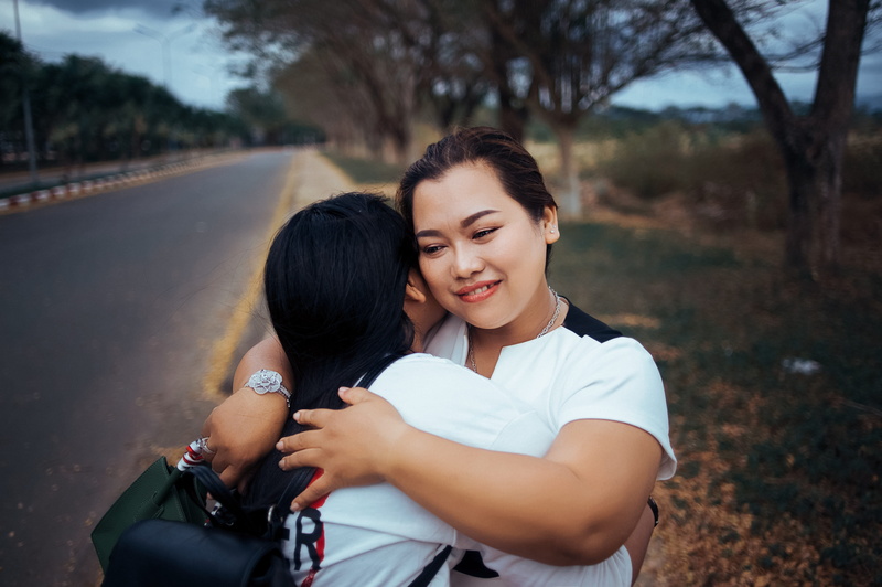 smiling, young, road, outdoors, facial expression, pathway, daylight, adult, front view, two people, standing, people, care, nature, focus on foreground