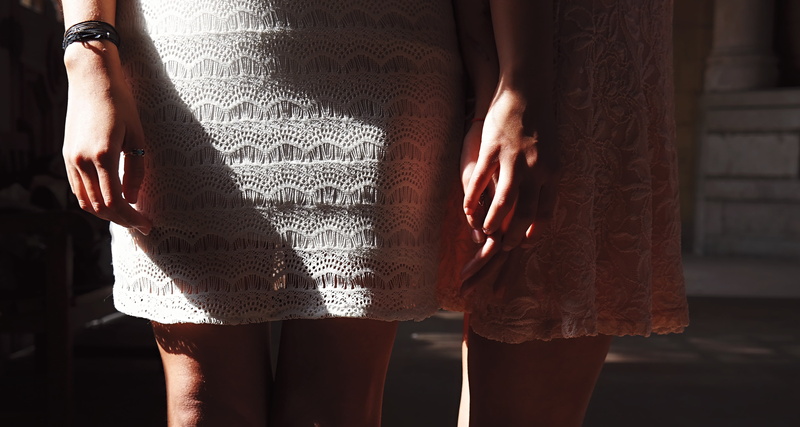indoors, sunny, front view, women, real people, adult, legs, skirt, female, dress, lifestyles, two, midsection, friends, holding hand, bracelet, clothing