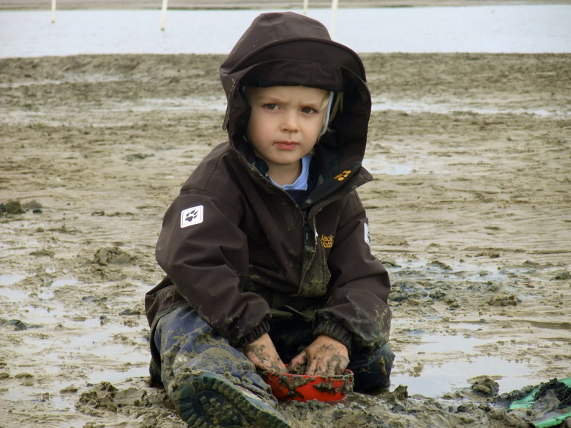 Child, hood - clothing, warm clothing, sea, one Person, looking at camera, lifestyles, poverty, people, Mud, front view, real people, innocence, males