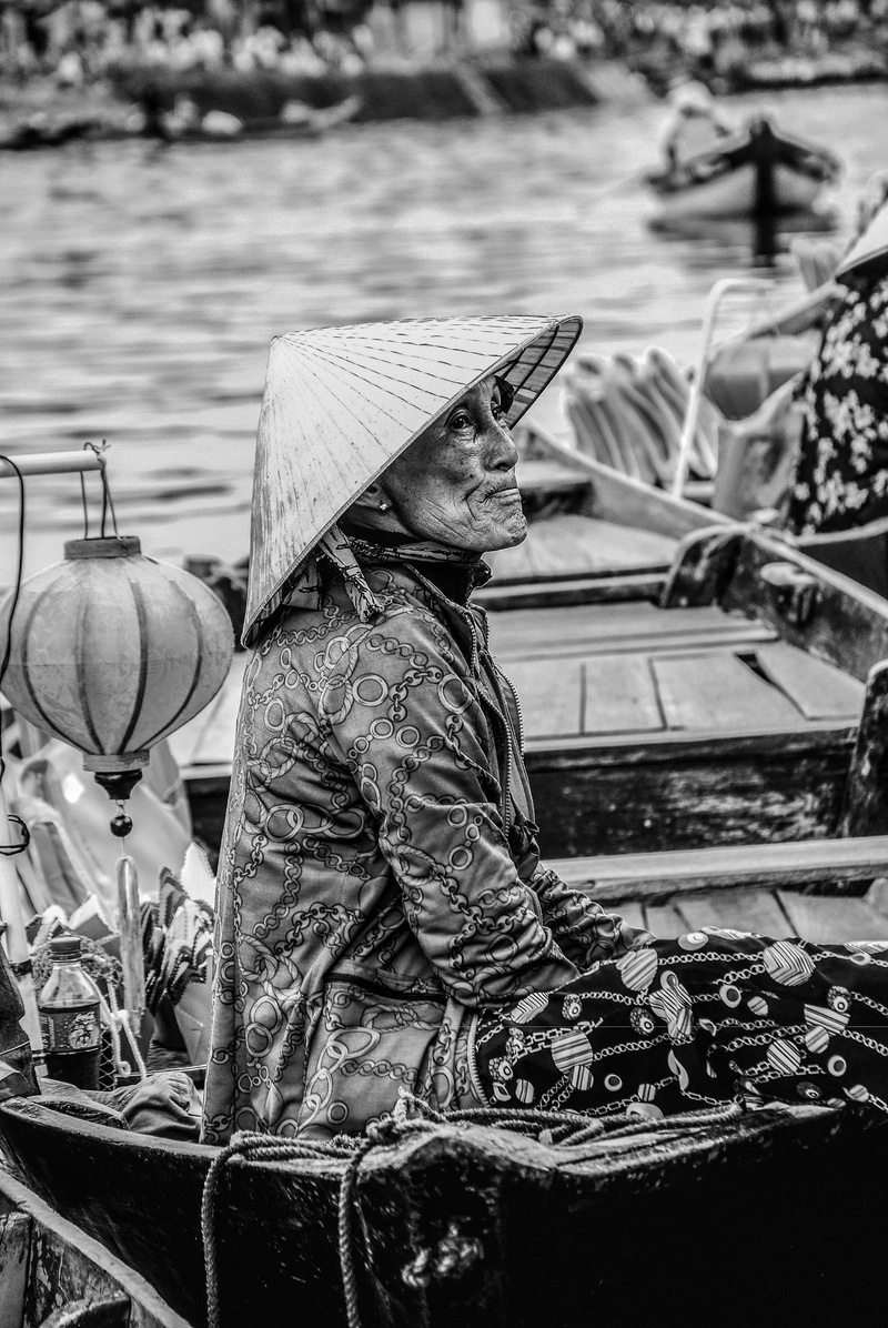 wearing, nautical vessel, riding, photography, sitting, traditional dress, hat, waist up, nature, clothing, monochrome, looking up, outdoor, cap, lady