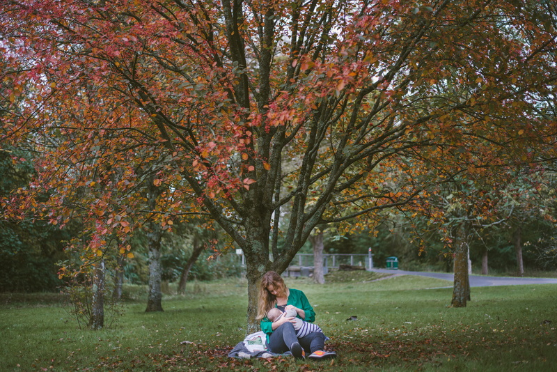 leisure activity, park, leaf, real people, nursing, one person, lifestyles, baby, grass, autumn, breastfeeding, 5K, park - man made space, plant, orange