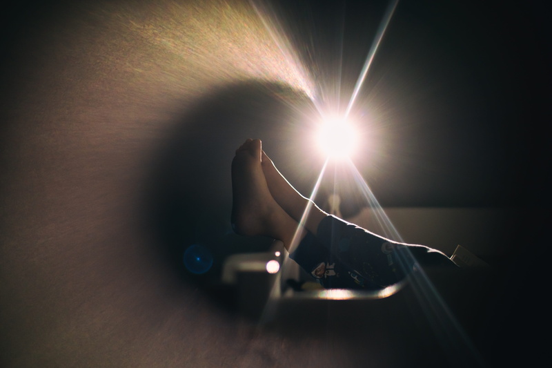 technology, human body part, light - natural phenomenon, human hand, unrecognizable person, hand, communication, bed, flare, bedtime, indoors, one person