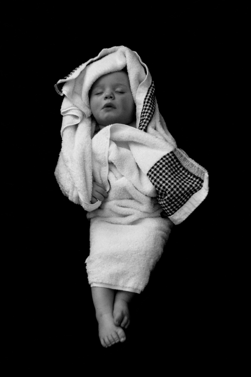 black background, offspring, emotion, child, bath, studio shot, 2K, sleep, bedtime, childhood, young, sleeping, kid, towel, toddler, casual clothing, softness