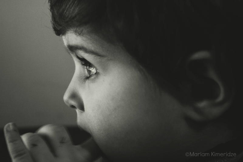 child, close-up, lifestyles, headshot, looking away, innocence, indoors, sadness, one person, body part, alone, people, black, depression - sadness, side view