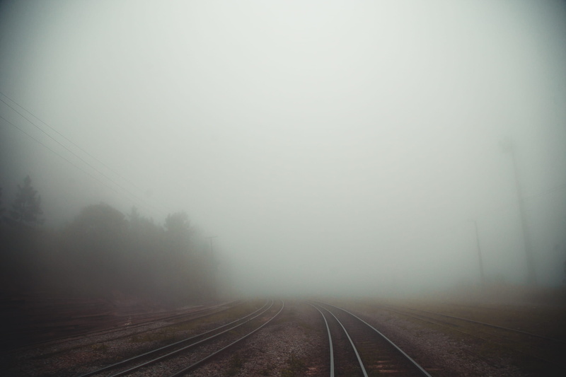 railroad, tranquil scene, direction, diminishing perspective, grey, no people, mist, beauty in nature, railroad track, train, plant, transportation, the way forward