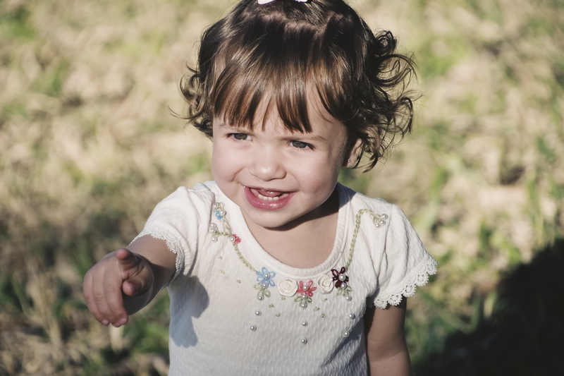 blurred background, grass, looking at camera, kid, one person, close-up, daylight, wear, real people, front view, leisure activity, little, child, waist up