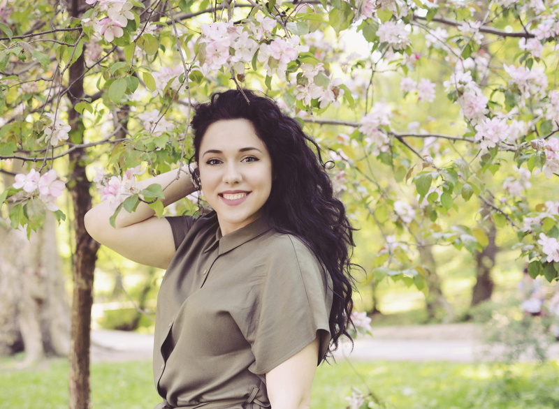 long hair, outdoors, near, leisure activity, tree, lifestyles, flowering plant, smile, plant, standing, woman, real people, nature, holding, hairstyle