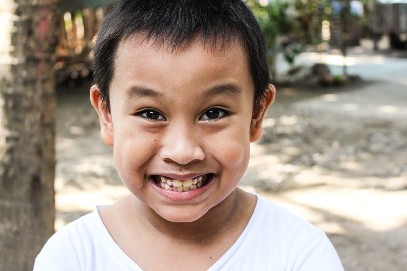portrait, childhood, smiling, human face, cute, mouth open, gap toothed, kids, happy, boy, focus on foreground, child, outdoors, lifestyles, 5K, looking at camera