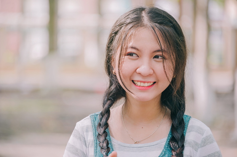 real people, looking at camera, focus on foreground, people, gap toothed, one person, smiling, hair, day, lifestyles, females, lady, girls, portrait, casual clothing