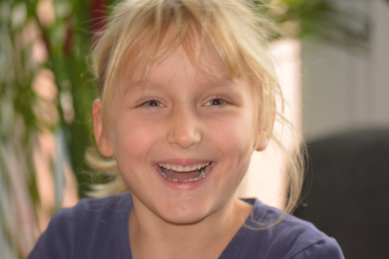 child, hair, teeth, headshot, laugh, gap toothed, close-up, offspring, toothy smile, girl, casual clothing, happiness, hairstyle, smiling, cheerful, emotion