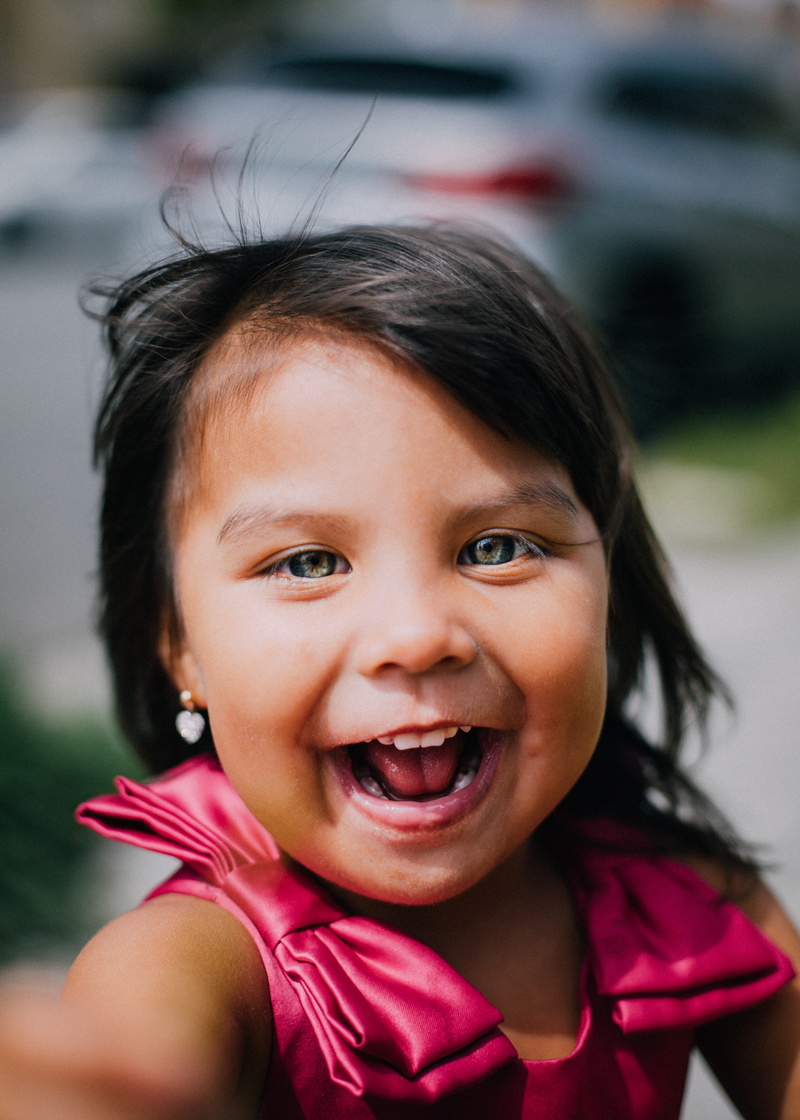 tank, red, cute, top, gap toothed, 5K, real people, focus on foreground, outdoors, front view, emotion, girl, cheerful, wearing, daytime, smiling, happiness