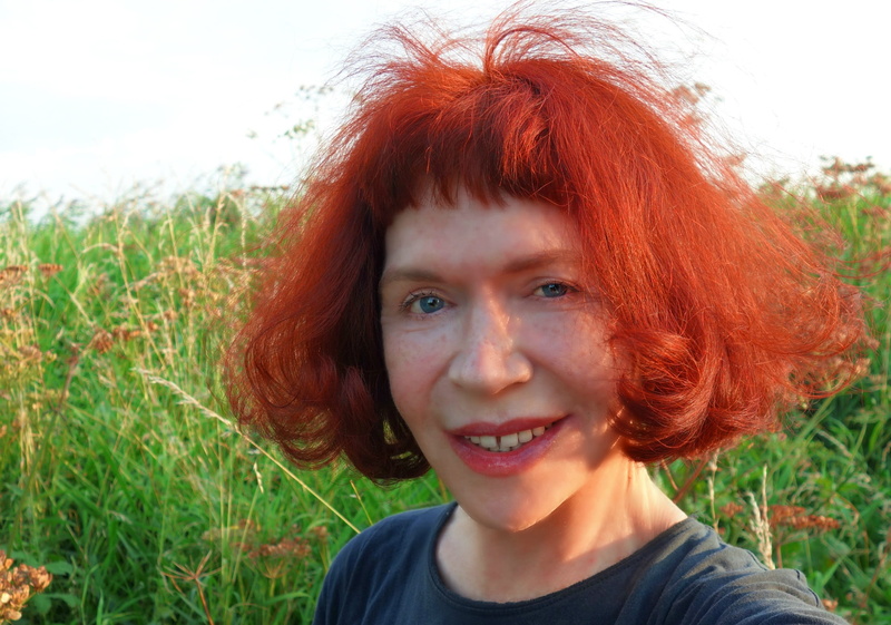 face, good looking, woman, looking at camera, innocence, bob, outdoors, hairstyle, smile, headshot, blue eyes, teeth, offspring, dyed red hair, plant, gap toothed