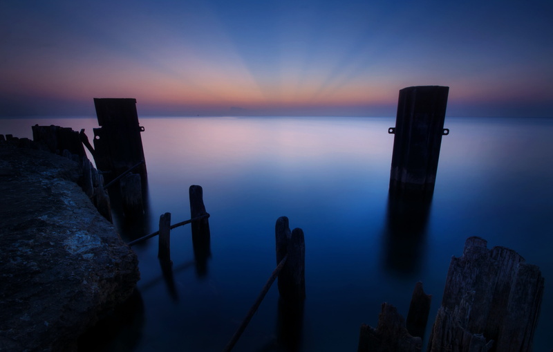 sea, sunset, water, sky, non-urban scene, solid, nature, outdoors, body, post, 4K, rock - object, scenics - nature, no people, idyllic, wood - material