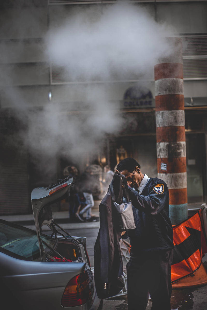 transportation, accident, smoke - physical structure, pollution, wear, three quarter length, security •, built structure, jacket, holding, security guard •