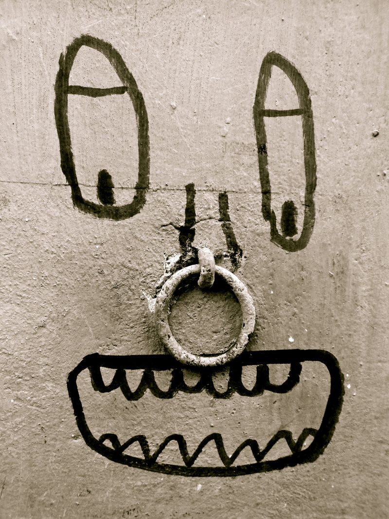 door, wall - building feature, face, craft, white, entrance, foot, communication, black color, old, sign, backgrounds, art, textured, ring, wall, close-up