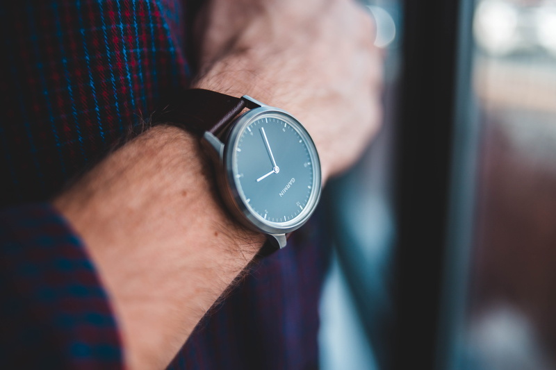 one person, digital watch, wrist, reading, day, time, gold, black, sports car, automobile, clock, strap, body part, person, stopwatch, car, instrument of time