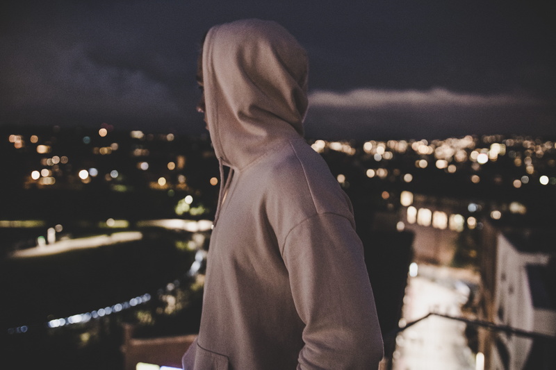 lifestyles, building exterior, architecture, evening, hood, leisure activity, clothing, obscured face, outdoors, focus, built structure, hood - clothing