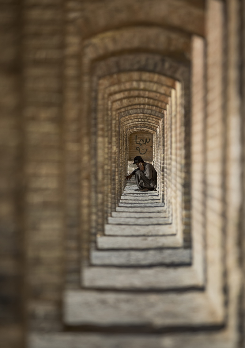 perspective, the past, outdoors, shadow, sitting, wall, knees, history, full length, surface level, the way forward, one person, built structure, man, architecture