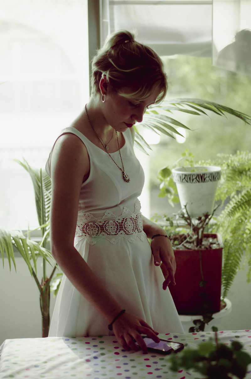 fashion, holding, looking, woman, mobile, standing, girl, indoors, mobile phone, beauty, young, lady, earring, women, looking down, sleeveless, using, potted plant
