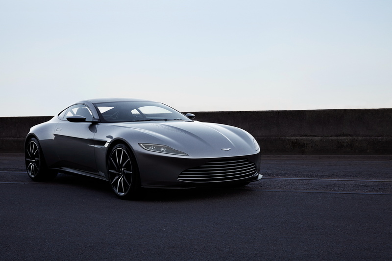motor vehicle, convertible, street, outdoors, shiny, silver colored, black, luxury, travel, clear sky, transportation, land vehicle, aston martin db10