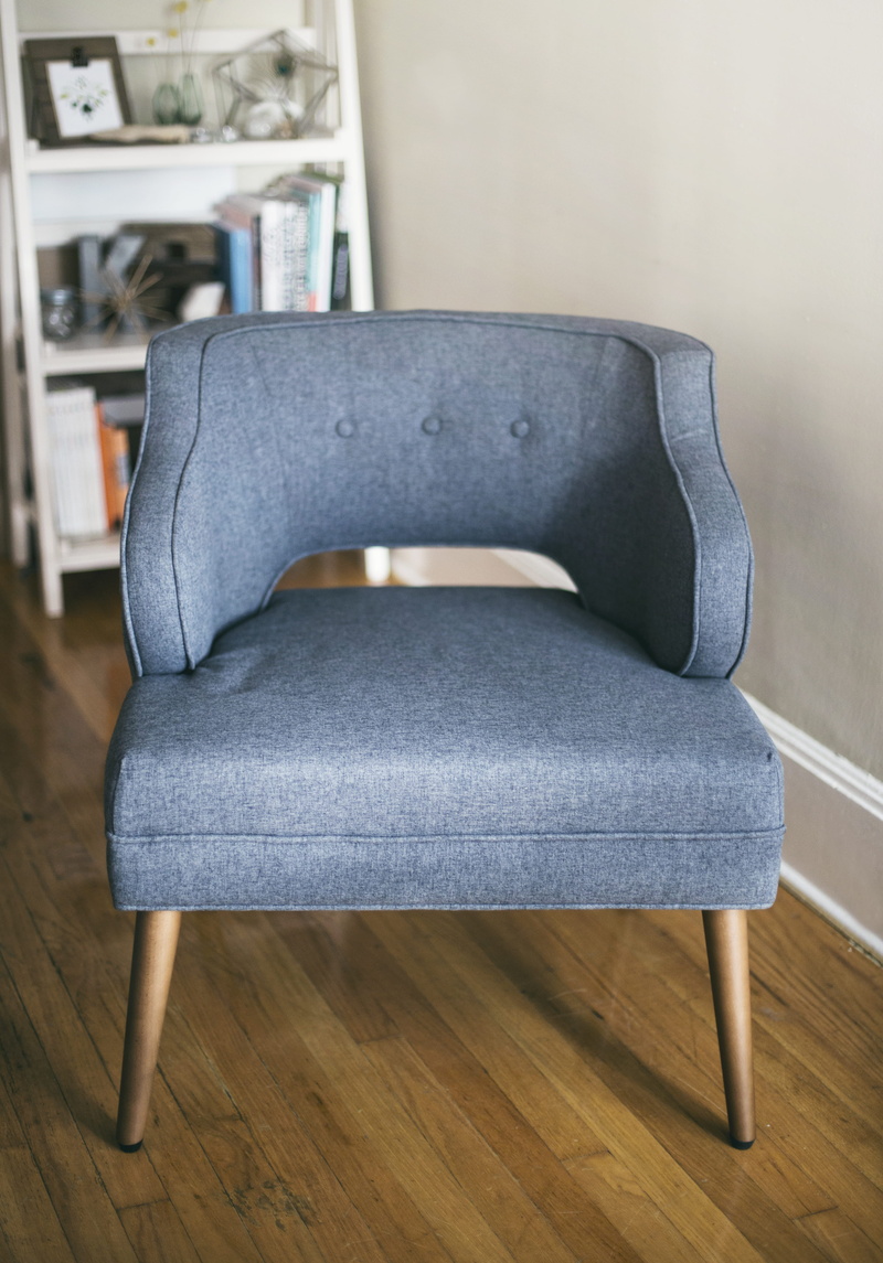 furniture, grey, inside, home interior, chair, focus on foreground, domestic room, padded, tufted, seat, photo, parquet floor, book, decor, modern, living room
