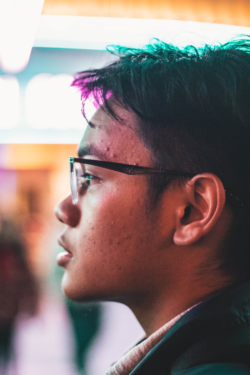 close-up, real people, indoors, looking away, boy, face, human face, teenager, lights, focus on foreground, eyeglasses, frame, portrait, lifestyles, side view