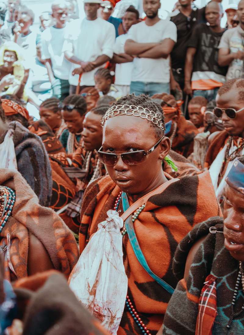 accessory, arts culture and entertainment, person, women, human, festival, lifestyles, orange, photographer, enjoyment, apparel, robe, standing, southafrica
